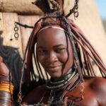 Young Himba woman dressed in traditional style in Namibia, Africa.